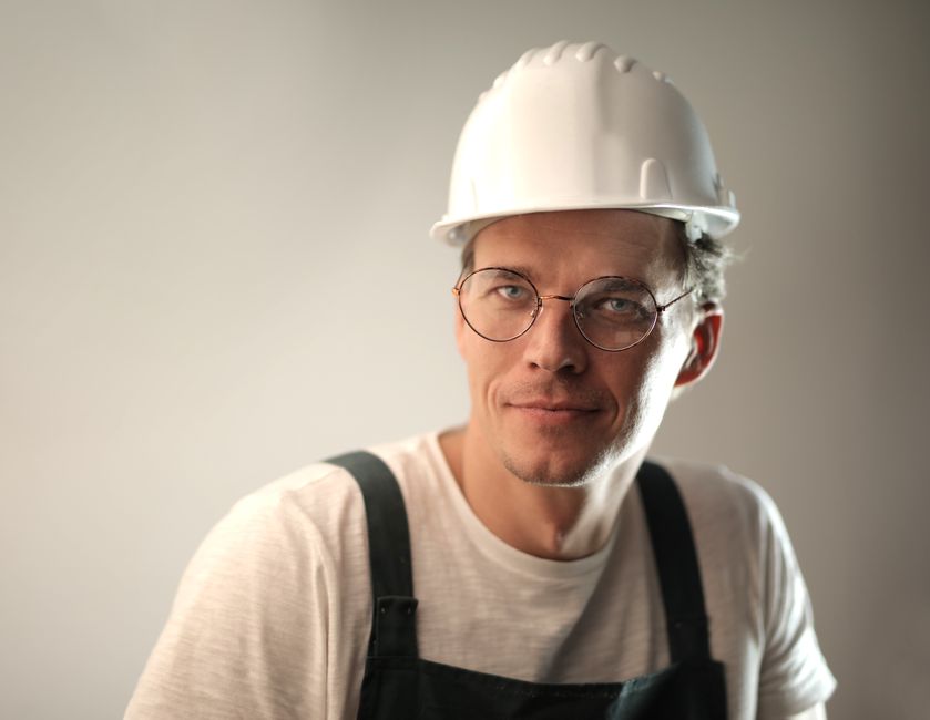 Friendly contractor evaluating home exterior