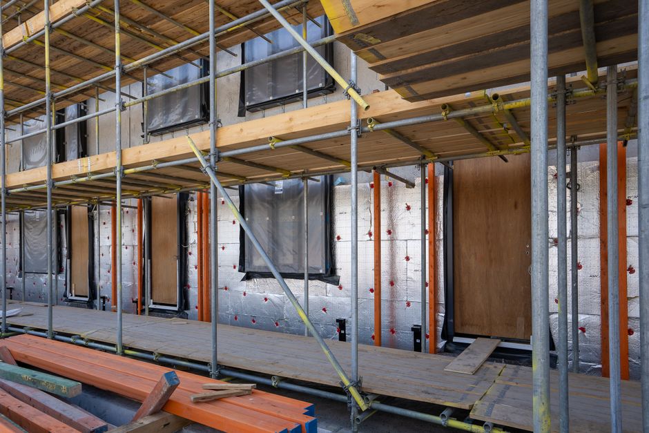 Professional installing home insulation in an attic